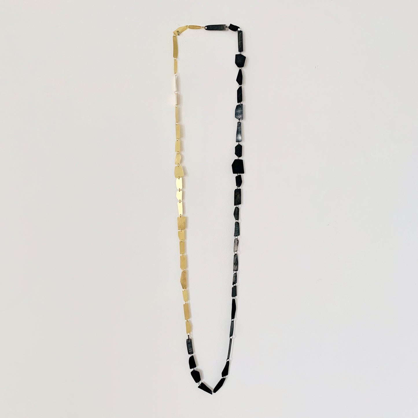 "Hand-sculpted Shards Necklace in 18 kt solid gold with polished edges and matte finish."