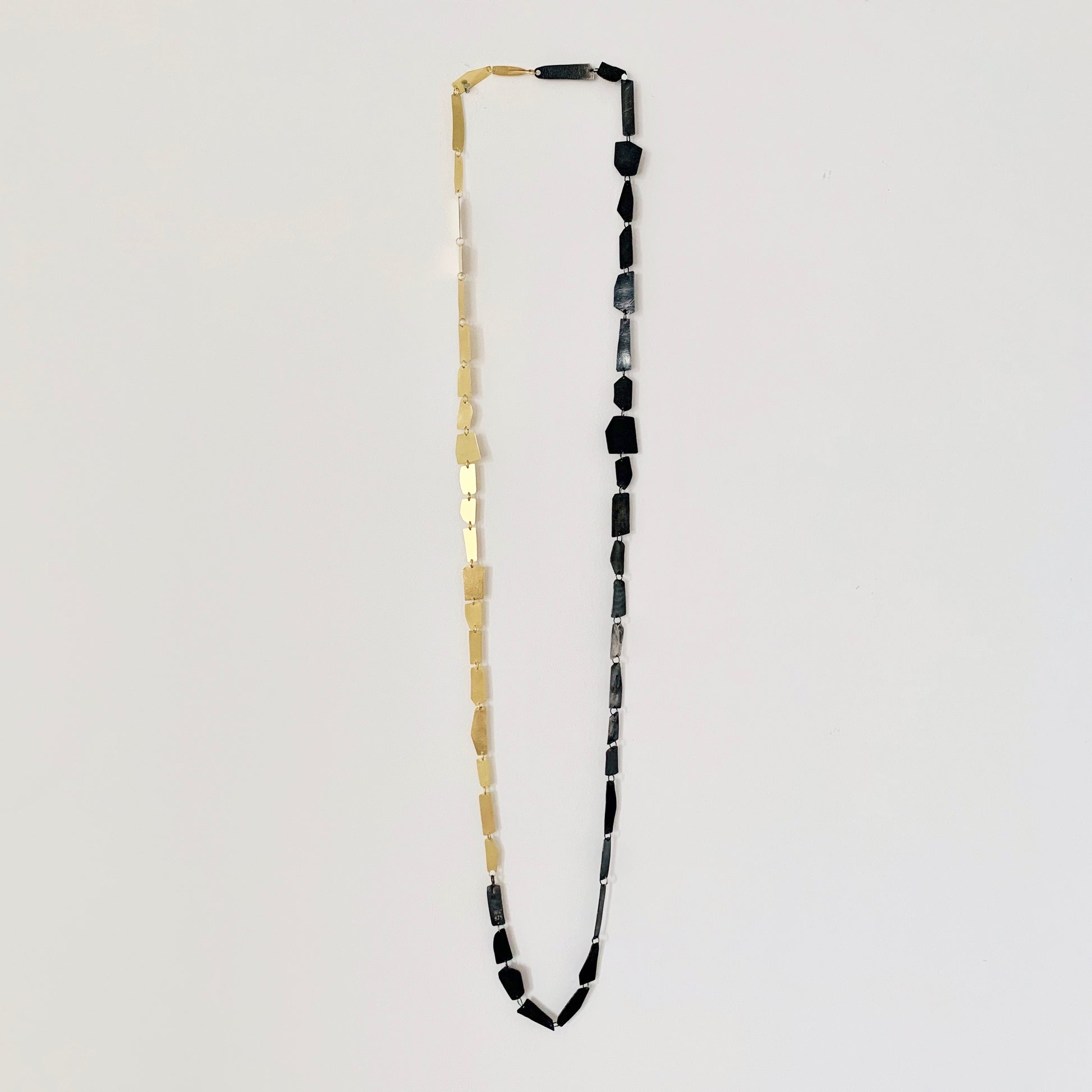 "Hand-sculpted Shards Necklace in 18 kt solid gold with polished edges and matte finish."