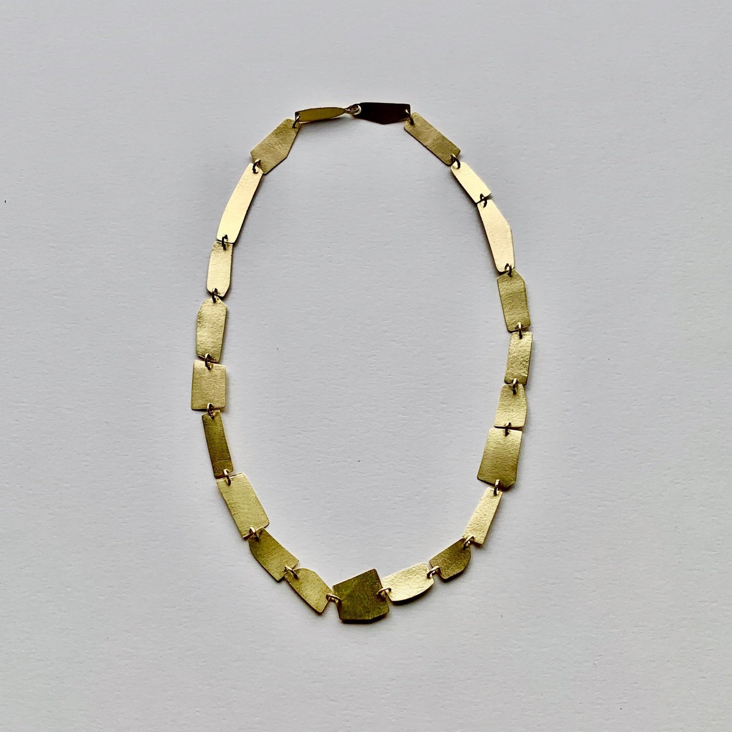 "Hand-sculpted Shards Necklace in 18 kt solid gold with polished edges and matte finish."